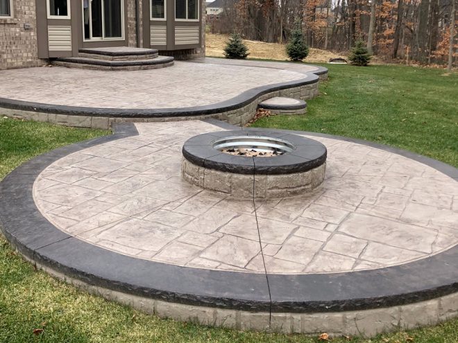 stamped concrete patio with firepit contractor